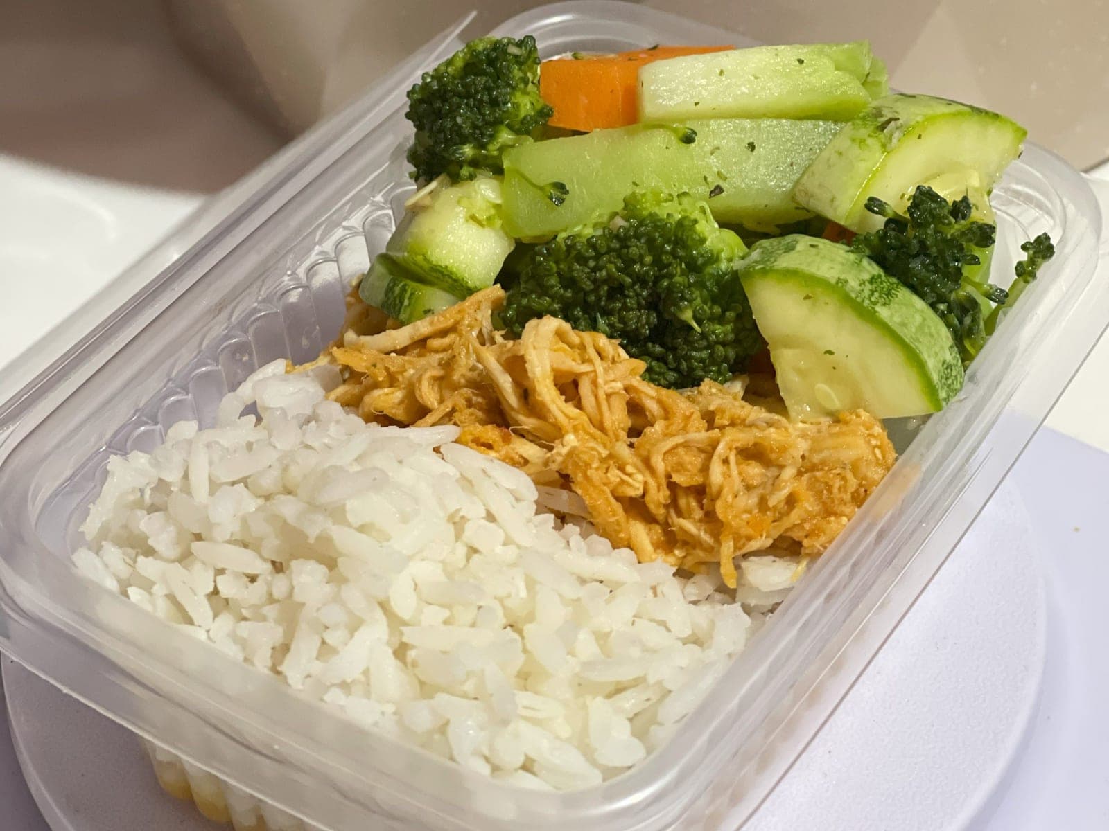 A meal prep box with rice, shredded chicken and mixed vegetables