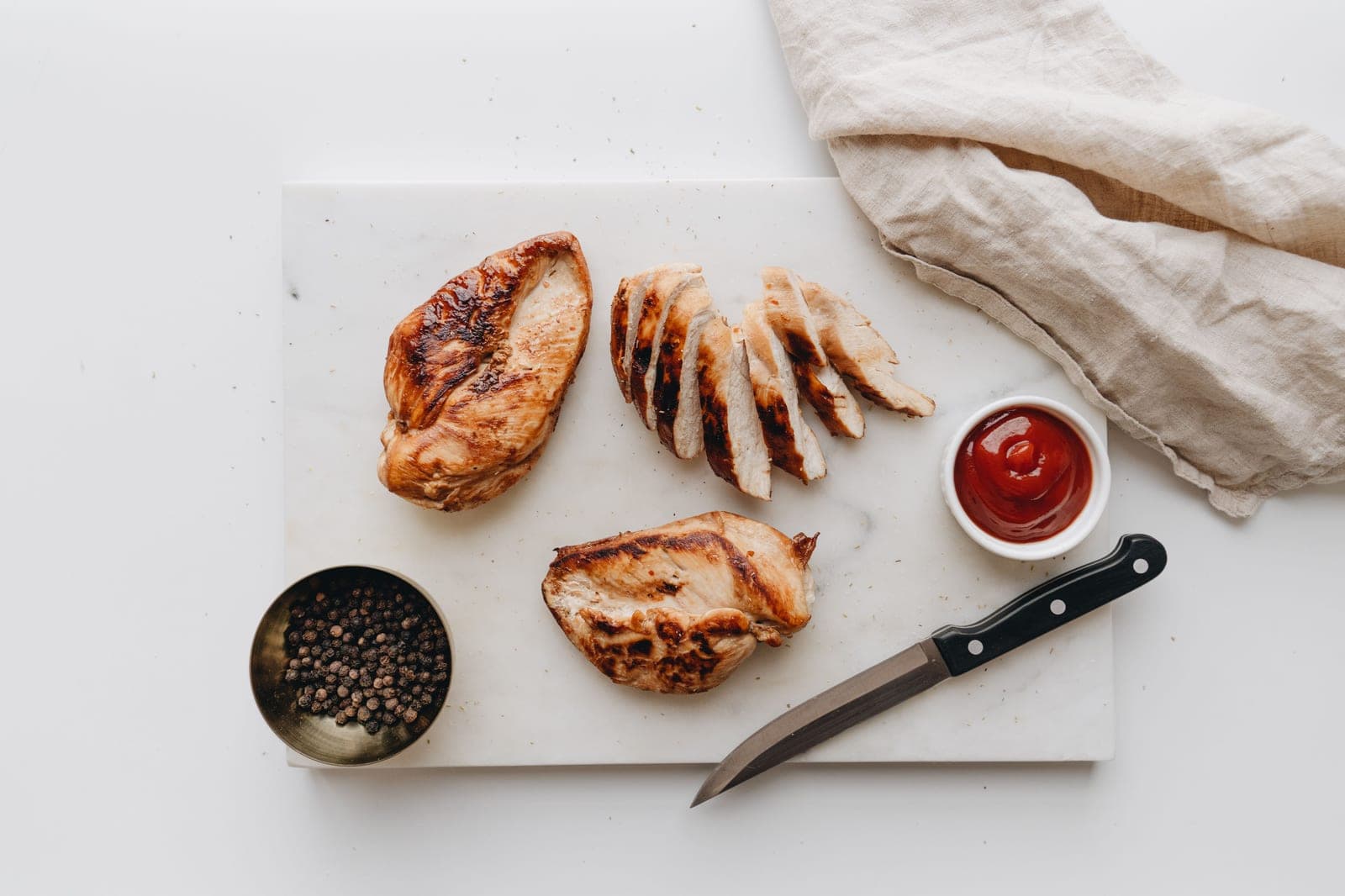 Sliced grilled chicken breast on a cutting board