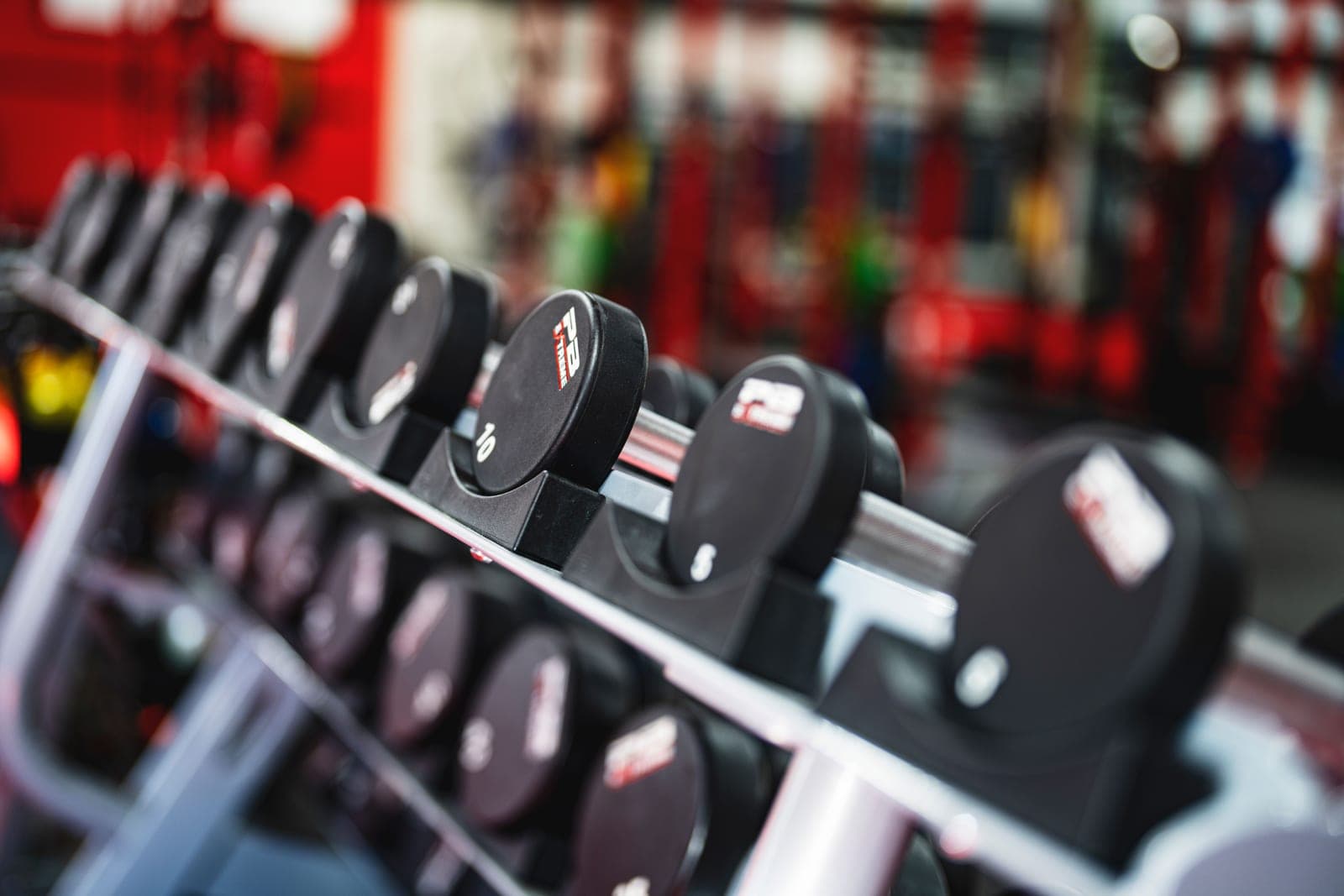 A row of dumbbells on a rack in a gym