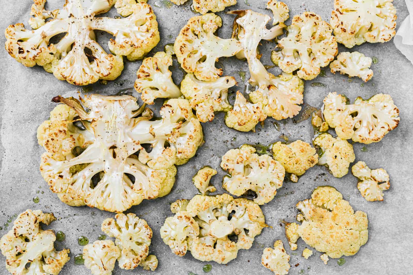 Roasted cauliflower slices on a baking sheet