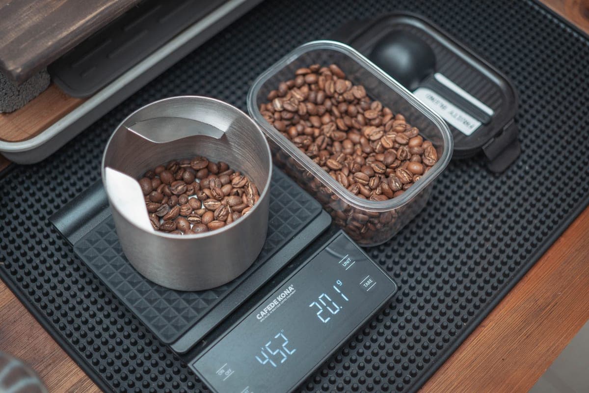 Coffee beans being weighed on a digital kitchen scale