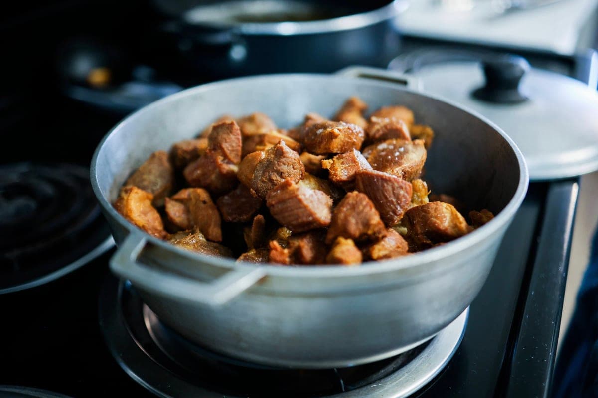 Pieces of cooked meat in a large pot